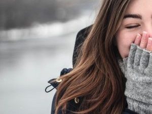 woman in winter clothes closed eyes